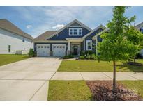 Charming single-story home boasts a manicured lawn, attached two-car garage, and welcoming front porch at 13339 Mcguffy Dr, Huntersville, NC 28078