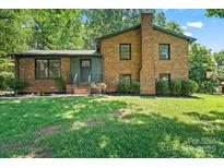 Charming brick home featuring a well-manicured lawn and classic architectural details at 1510 Sansberry Rd, Charlotte, NC 28262
