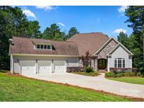 Charming home with a stone and siding facade, three-car garage, and well-maintained landscaping on a sunny day at 1687 Sierra Rd, York, SC 29745