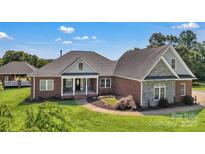Beautiful brick home with a well-manicured lawn and inviting front porch, exuding curb appeal and charm at 2145 Jack Wilson Rd, Shelby, NC 28150
