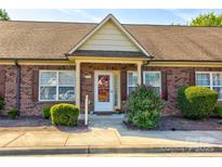 Charming brick condo with a well-manicured lawn and decorative shutters at 2785 Clover Nw Rd, Concord, NC 28027