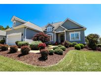 Charming home featuring a manicured lawn, tasteful landscaping, and an attached garage at 406 Spyglass Hill Pl, Salisbury, NC 28144