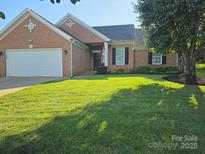 Charming brick home with a well-maintained lawn and an attached two-car garage at 4204 Canipe Dr, Charlotte, NC 28269