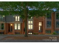 Charming brick townhomes with well-maintained landscaping and inviting entrances at 460 E 33Rd St, Charlotte, NC 28205
