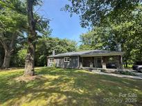 Charming single-story home with a stone front porch and large, shaded front yard at 6616 Love Mill Rd, Monroe, NC 28110