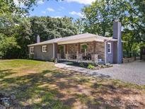 Charming single-story home featuring stone accents, a covered porch, and a well-maintained front yard at 6616 Love Mill Rd, Monroe, NC 28110