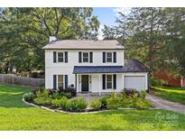 Charming two-story home with white siding, black shutters, and a well-manicured front yard at 11401 Lone Star Cir, Charlotte, NC 28226