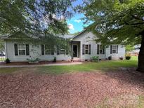 Charming single-story home with muted siding, dark shutters, and a neatly maintained front yard at 13221 Brandywine Ln, Midland, NC 28107