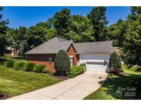 Charming brick home with well-manicured lawn and a two-car garage at 2124 Congress Ct, Kannapolis, NC 28083
