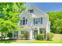 Charming two-story home with bright green shutters and lush landscaping, well maintained at 2830 Grosbeak Ln, Charlotte, NC 28269