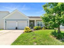 Charming single-story home with a manicured lawn, two-car garage, and inviting front porch at 3296 Saddlebrook Dr, Midland, NC 28107