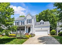 Charming two-story home featuring a well-manicured lawn, attached garage, and inviting curb appeal at 3535 Selwyn Farms Ln, Charlotte, NC 28209
