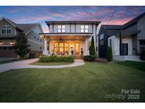 Inviting two-story home featuring a spacious front porch, manicured lawn, and a blend of traditional and modern design elements at 508 Mcalway Rd, Charlotte, NC 28211