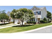 Charming townhome with beautiful landscaping and a well-manicured front yard at 621 Pine Links Dr, Tega Cay, SC 29708