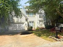 Charming two-story home with a well-manicured lawn, light siding, a two-car garage, and a welcoming front entrance at 6311 Red Maple Dr, Charlotte, NC 28277