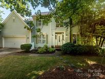 Charming two-story home with manicured lawn, lovely garden and a welcoming front porch perfect for relaxation at 6311 Red Maple Dr, Charlotte, NC 28277