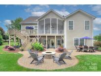Spacious backyard with a fire pit area, multilevel deck and screened porch perfect for entertaining at 6326 Jepson Ct, Charlotte, NC 28214
