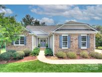 Charming stone home with manicured landscaping, inviting entrance, and beautiful curb appeal at 6326 Jepson Ct, Charlotte, NC 28214
