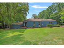 Charming one-story home with blue siding, mature trees, and a well-maintained front lawn at 640 Lochaven Rd, Weddington, NC 28173