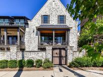 Charming white brick home featuring a private balcony and a secure gated entrance at 6531 Hazelton Dr, Charlotte, NC 28210