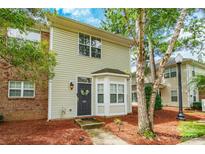 Charming two-story home with a cozy bay window, a decorative wreath, and beautiful landscaping at 11521 Savannah Creek Dr, Charlotte, NC 28273