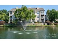 Stunning multi-story condo complex overlooking a tranquil lake with a fountain at 18730 Nautical Dr # 102, Cornelius, NC 28031