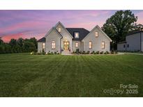 Charming brick home with a manicured lawn and professionally landscaped yard; a welcoming sight for prospective buyers at 19 Berea Baptist Church Rd, Stanfield, NC 28163