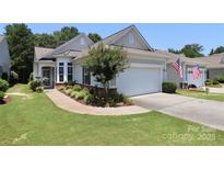 Charming home with manicured lawn, flower beds, and a two-car garage, located in a desirable community at 3079 Azalea Dr, Fort Mill, SC 29707