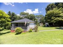 Charming one-story home with a screened front porch and a spacious, green lawn at 3419 Boat Club Rd, Belmont, NC 28012