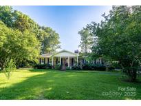 Charming brick home with a well-maintained lawn and mature trees at 402 Scotland Dr, Kings Mountain, NC 28086