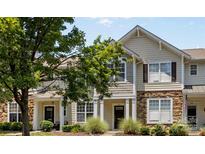 Charming townhouse with a welcoming front yard featuring lush greenery and a well-maintained lawn at 514 Bent Leaf Ct, Fort Mill, SC 29708