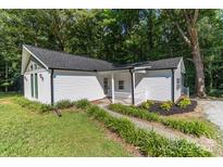 Charming single-story home with a white exterior, new roof, manicured landscaping and inviting front porch at 7032 Waxhaw Hwy, Lancaster, SC 29720