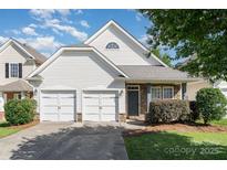 Charming home features a two-car garage, stone accents, and a well-maintained front yard and lovely curb appeal at 9644 Marquette Nw St, Concord, NC 28027