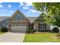 Charming single-story home features a well-manicured lawn, complemented by a two car garage and tasteful landscaping at 1108 Mayapple Way, Belmont, NC 28012