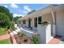 Charming home featuring a welcoming front porch with flower boxes and a freshly landscaped garden bed at 172 Wildwood Loop, Statesville, NC 28625