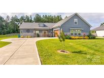 Charming home featuring a well-manicured lawn, stone accents, and a cozy covered entryway at 307 Stoneyard Rd, Richfield, NC 28137