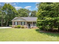 Charming brick ranch-style home with well-manicured lawn and inviting front porch at 551 Sand Trap Dr, York, SC 29745