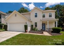 Charming two-story home with a well-manicured lawn and inviting front porch perfect for a Gathering at 6422 Gatesville Ln, Charlotte, NC 28270