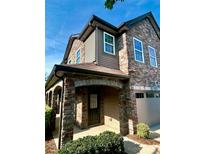 Charming two-story home with stone accents, arched entryway, and attached garage at 809 Ayrshire Ave, Fort Mill, SC 29708