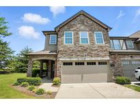 Charming two-story townhome featuring a stone facade, covered entryway, and attached two-car garage at 809 Ayrshire Ave, Fort Mill, SC 29708