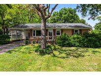 Charming brick home with mature trees and a welcoming, covered carport, offering both curb appeal and practical convenience at 814 W Gold St, Kings Mountain, NC 28086
