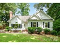 Charming single-story home featuring a well-maintained lawn and a classic white facade with black shutters at 975 Pine Knoll Rd, Fort Mill, SC 29715