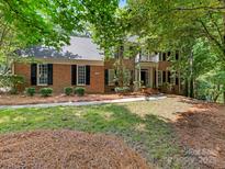 Charming two-story brick home with a well-maintained lawn and mature trees at 10333 Scott Gate Ct, Charlotte, NC 28277