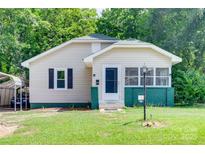 Charming single-story home with a well-manicured lawn and covered parking at 104 W Maryland Ave, Bessemer City, NC 28016