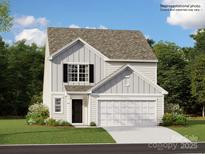 Charming two-story home with a well-manicured lawn and attached two-car garage at 105 Watuga Pl, Statesville, NC 28625