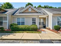 Charming townhouse with well-maintained landscaping, neutral siding, and inviting front porch at 1504 Harpers Inlet Dr, Lake Wylie, SC 29710