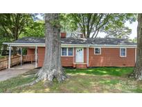 Charming single-story brick home featuring a covered carport and well-maintained front lawn at 151 Third Creek Rd, Statesville, NC 28677