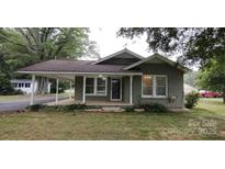Charming single-story home featuring a covered porch, brick facade, and well-maintained landscaping at 1521 N Piedmont Ave, Kings Mountain, NC 28086