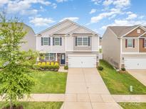 Charming two-story home featuring a well-maintained lawn and inviting curb appeal with blue shutters at 1624 Savory Ln, Charlotte, NC 28216