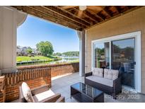 Inviting outdoor patio with brick accents and comfortable seating overlooking a serene waterfront view at 18511 Harborside Dr, Cornelius, NC 28031